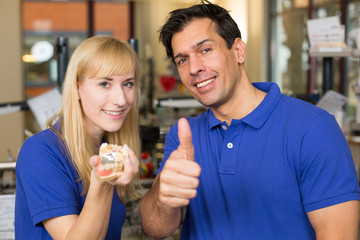 Dental technicians showing thumbs