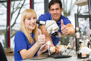 Dental technicians showing thumbs up