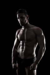 Fototapeta premium muscled man on a black background