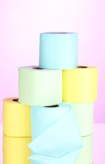bright rolls of toilet paper on pink background