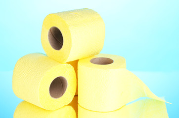 yellow rolls of toilet paper on blue background