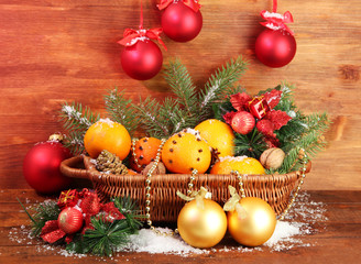 christmas composition in basket with oranges and fir tree,