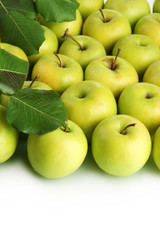 juicy apples with green leaves, close up