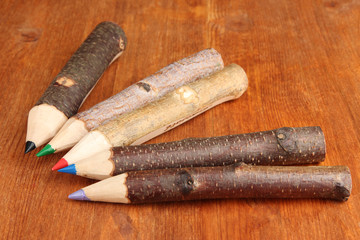 Colorful wooden pencils on wooden table
