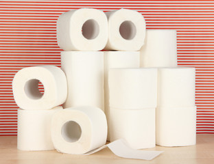 Rolls of toilet paper on striped red background