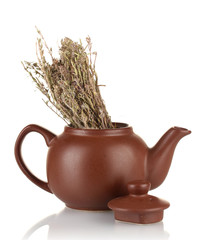 Dried herbs in teapot, isolated