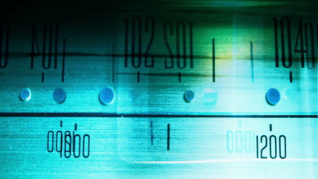 a glowing radio with the marker running through stations