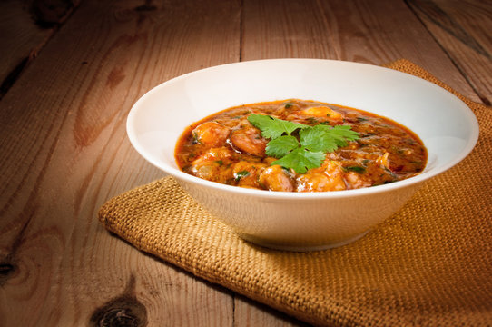 shrimp in a sauce on a wooden table