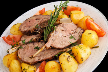 Rack of lamb with fried potatoes isolated on black