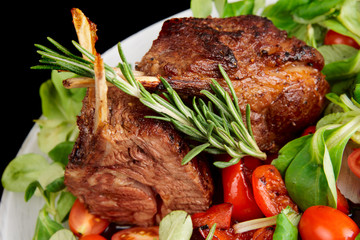 Rare fried rack of lamb isolated on black © Kondor83