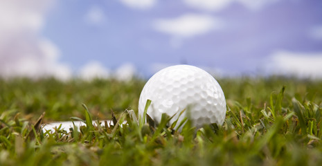 Golf ball on green meadow