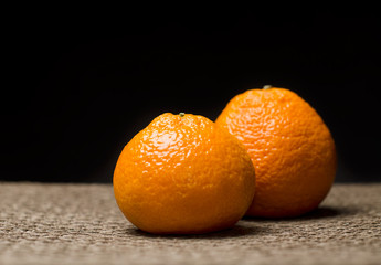 Couple of tangerines against dark background