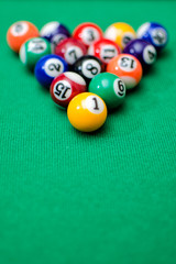 Pool game balls on green felt table