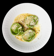 Ravioli in plate close-up, isolated on black