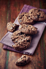 Dark chocolate chip cookies on a napkin