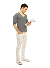 Young man standing with book, isolated on white background