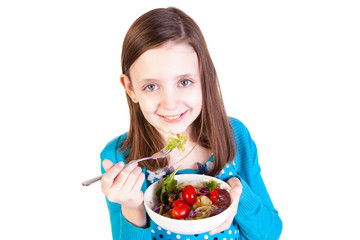 a young girl eating a healthy salad