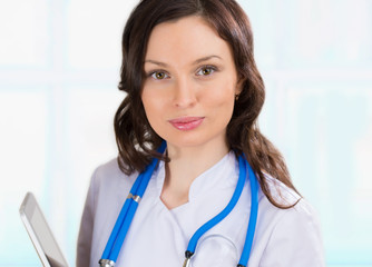 Doctor working on a digital tablet at her office at hospital