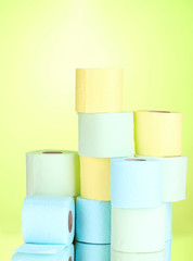 bright rolls of toilet paper on green background