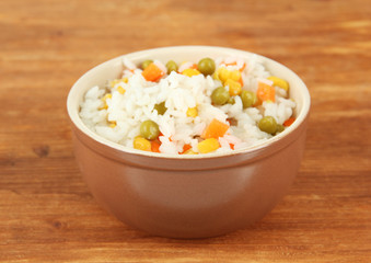 Risotto in bowl on wooden background