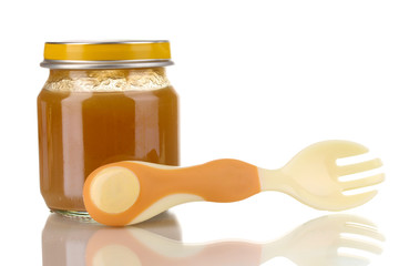 Useful and tasty baby food with beige small fork isolated