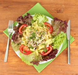 Tasty italian pasta with seafood on wooden background