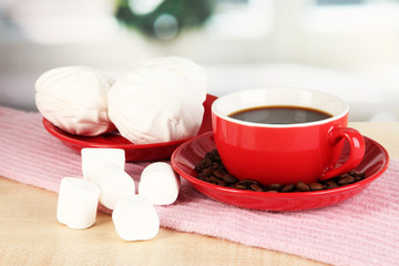 cup of coffee with scarf on table in room