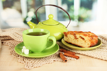 cup of tea with scarf on table in room