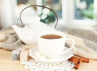 cup of tea with scarf on table in room