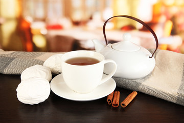 cup of tea with scarf on table in room