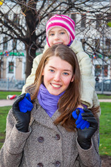 young mother walking in the park with a beautiful daughter