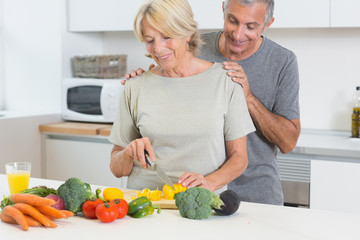 Couple cutting vegetables together