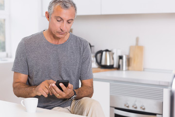 Focused man touching his smartphone