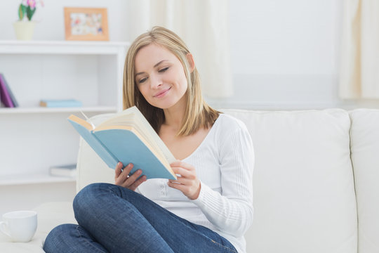 Happy Woman Reading Storybook At Home