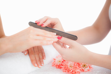 Close-up of woman filing fingernail