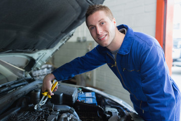 Fototapeta na wymiar Male mechanic fixing car engine