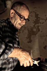 Caucasian elderly shoemaker man at traditional work