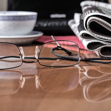 pile of newspaper & glasses