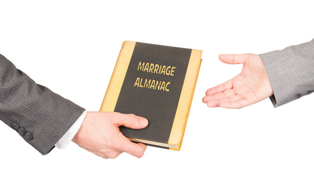 Man and woman holding a marriage almanac