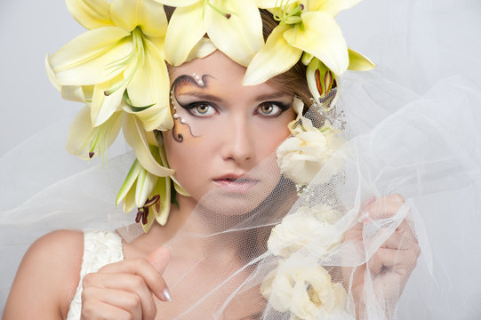 portrait of a beautiful girl with a garland of lilies and eustom