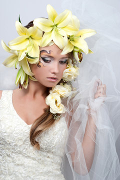 portrait of a beautiful girl with a garland of lilies and eustom