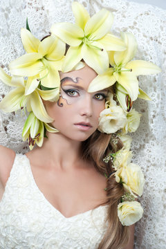 portrait of a beautiful girl with a garland of lilies and eustom