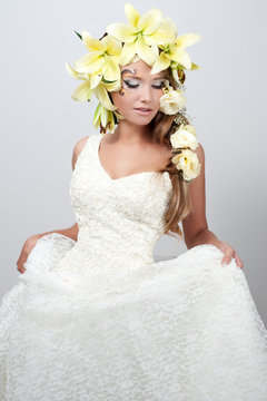 portrait of a beautiful girl with a garland of lilies and eustom
