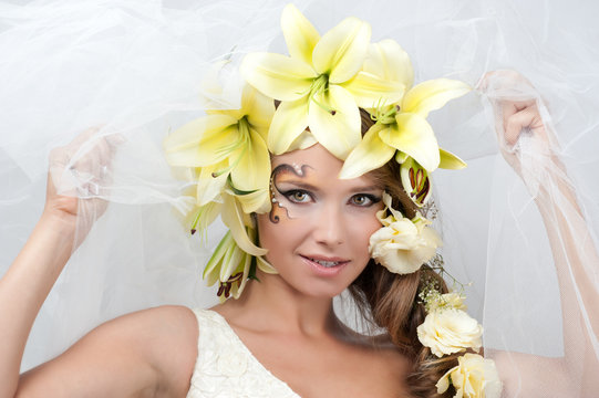portrait of a beautiful girl with a garland of lilies and eustom