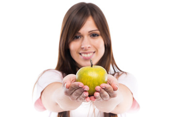 Smiling young woman with apple. Focus on apple