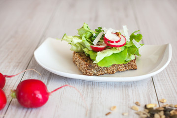 Radishes with healthy sandwich with salad