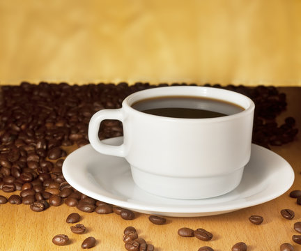 White cup of coffee on a yellow background