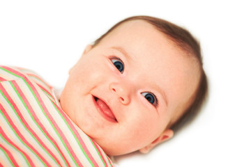 Nice smiling  baby with open blue eyes close up