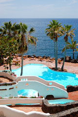 View on the beach, palms and swimming pool of luxury hotel, Tene