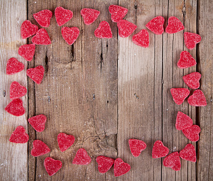 heart shape candy on wooden plank